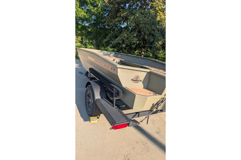 Slide: The Image of 2027 Tracker Grizzly 1553 Timber boat on trailer, parked outdoors. - 17