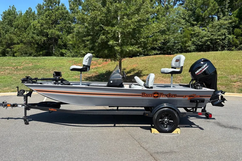 The Image of 2027 Tracker Bass Tracker Classic Limited boat on trailer, parked outdoors. - 0