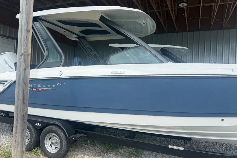 Slide: The Image of 2025 Monterey Elite 27 OB boat on trailer in storage facility. - 3