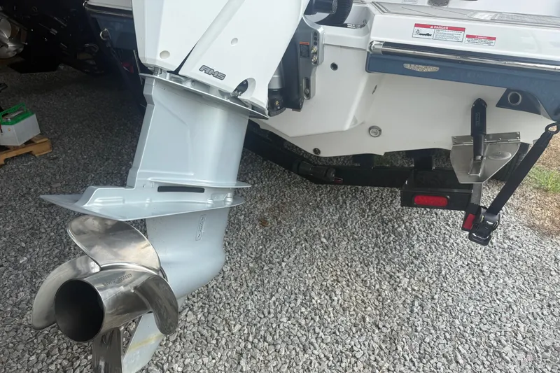 Slide: The Image of 2025 Monterey Elite 27 OB boat engine and propeller on gravel surface. - 6