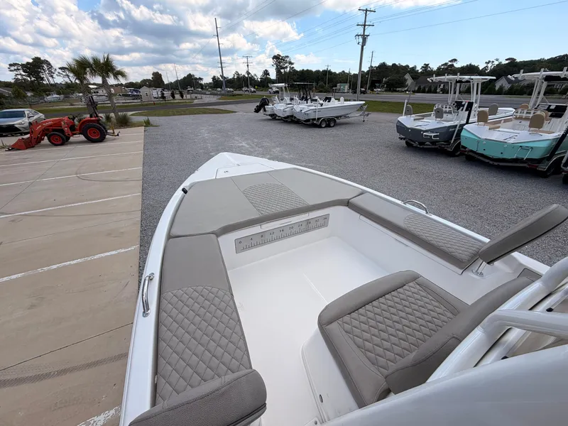 Slide: The Image of The image shows the deck of a 2027 Savannah 210X boat with gray upholstery. - 10