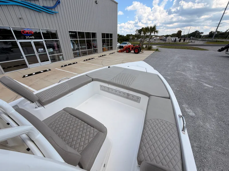Slide: The Image of The image shows the deck of a 2027 Savannah 210X boat with gray upholstery. - 11