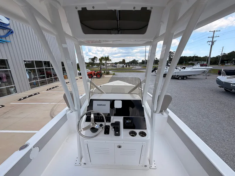 Slide: The Image of The image shows the cockpit of a 2027 Savannah 210X boat. It features a modern helm with a steering wheel and electronic displays. - 8