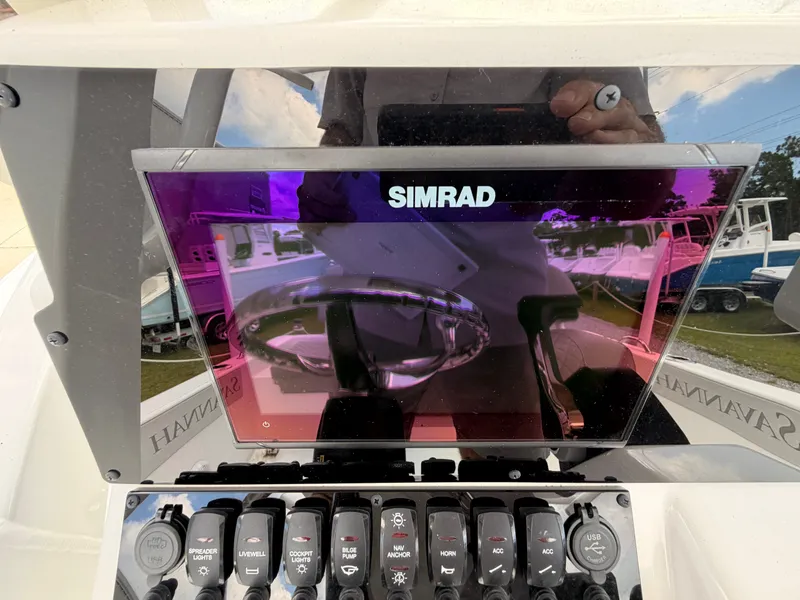 Slide: The Image of The image shows a Simrad display on a 2027 Savannah 210X boat. - 9