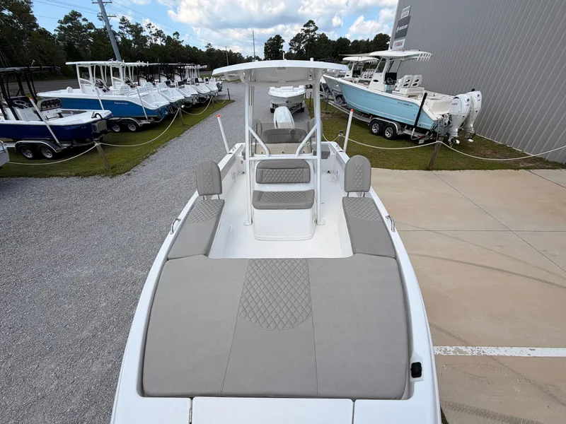 Slide: The Image of The image shows a 2027 Savannah 210X boat with gray upholstery and a modern design. - 12