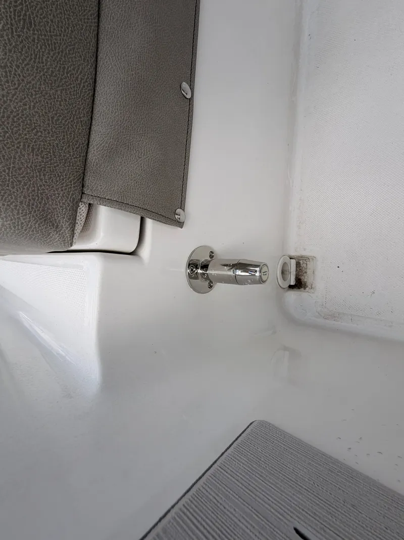 Slide: The Image of Close-up of a boat detail with gray upholstery and metal fitting. - 16