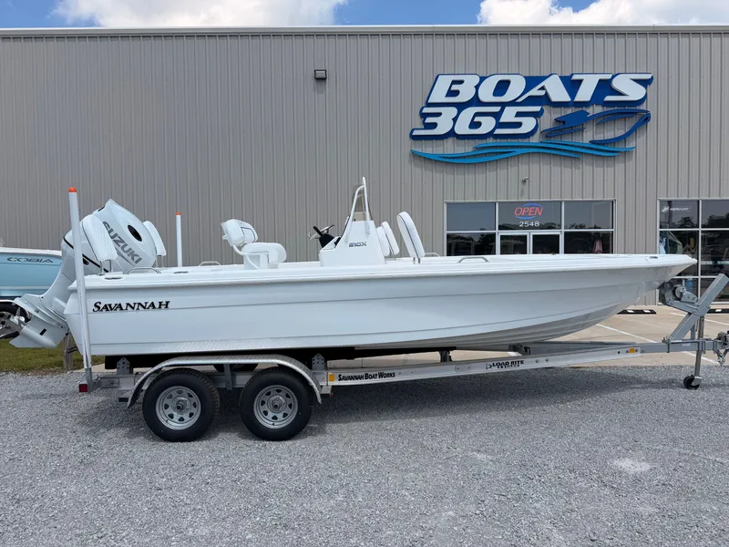 The Image of A white 2027 Savannah 210X boat on a trailer in front of a boat dealership. - 0