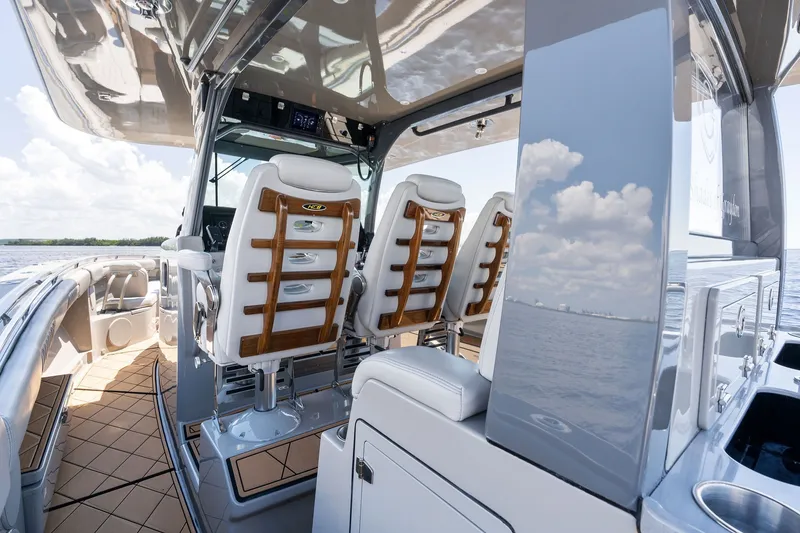 Slide: The Image of Interior view of 2023 HCB 42 Lujo boat with luxurious seating and ocean backdrop. - 48
