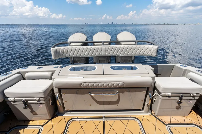 Slide: The Image of 2023 HCB 42 Lujo boat interior with luxurious seating and storage, overlooking calm waters. - 29