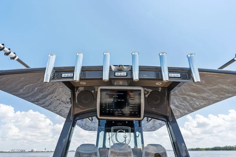 Slide: The Image of 2023 HCB 42 Lujo boat dashboard with rod holders and electronic display. - 37