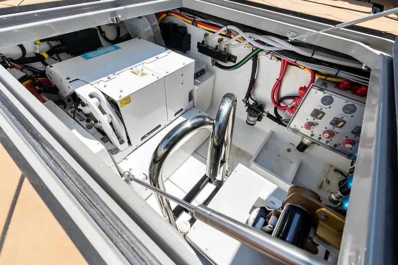 Slide: The Image of Engine compartment of 2023 HCB 42 Lujo boat, showcasing wiring and mechanical components. - 61