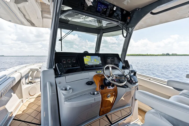 Slide: The Image of 2023 HCB 42 Lujo boat helm with advanced navigation system on open water. - 41