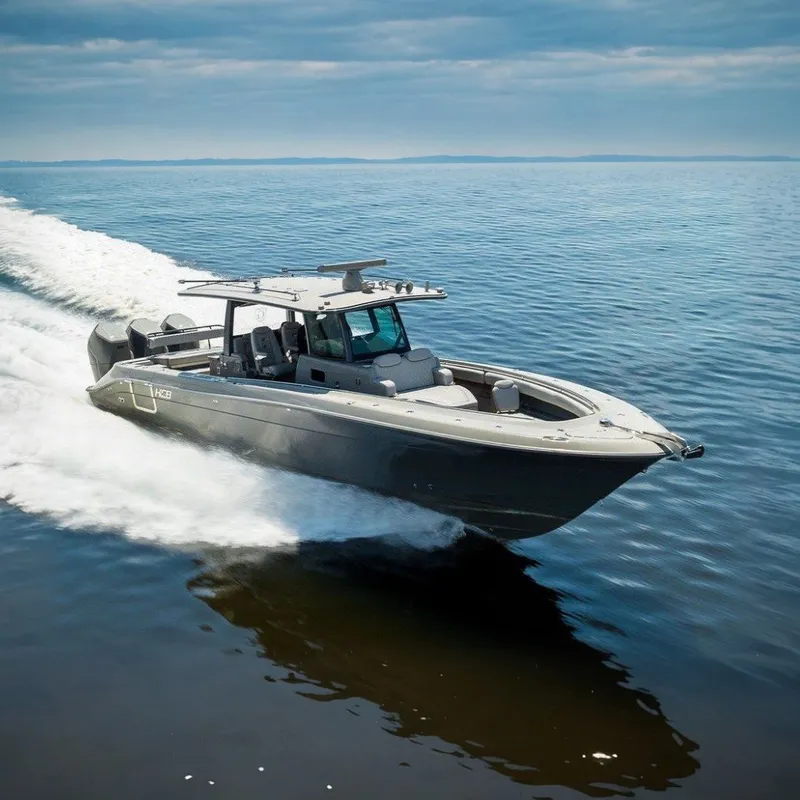 The Image of A 2023 HCB 42 Lujo speeds across calm water under a cloudy sky. - 0
