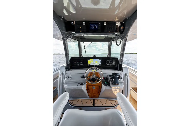 Slide: The Image of Helm of 2023 HCB 42 Lujo boat with advanced navigation displays and controls. - 38