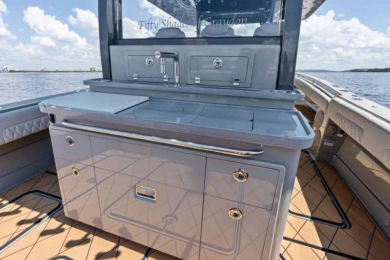 Slide: The Image of 2023 HCB 42 Lujo boat interior with sleek cabinetry and ocean view. - 35