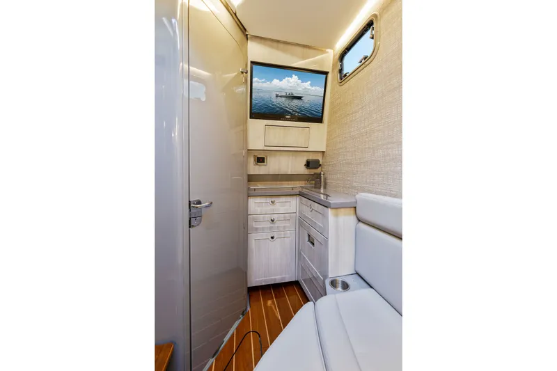 Slide: The Image of Interior of 2023 HCB 42 Lujo boat with modern cabinetry and seating. - 56