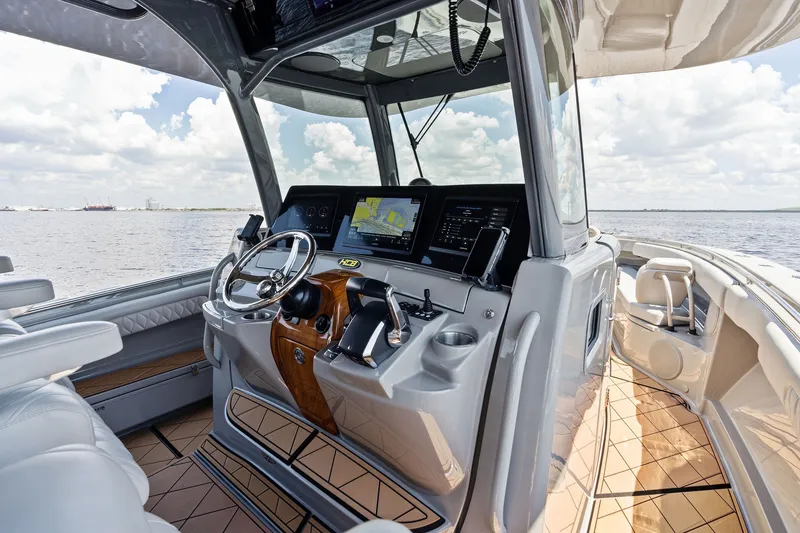 Slide: The Image of Helm of 2023 HCB 42 Lujo boat with modern controls and navigation screens. - 40