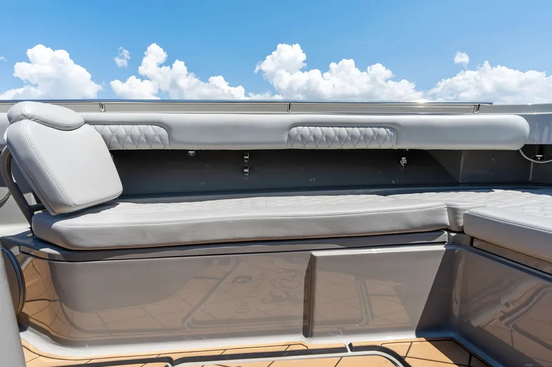 Slide: The Image of Luxury seating on 2023 HCB 42 Lujo boat under a clear blue sky. - 23