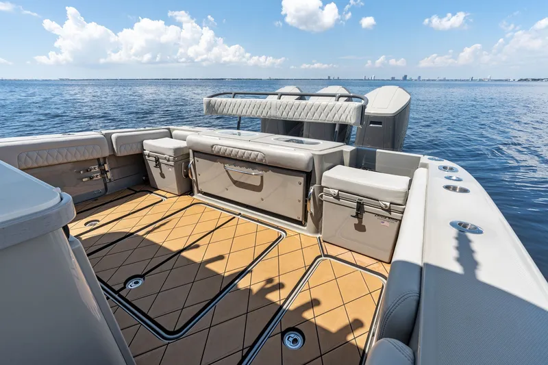 Slide: The Image of 2023 HCB 42 Lujo boat deck with seating and storage, overlooking calm ocean waters. - 24