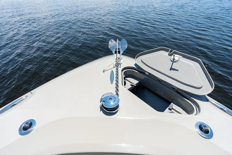 Slide: The Image of 2023 HCB 42 Lujo boat bow with anchor and open hatch on water. - 17