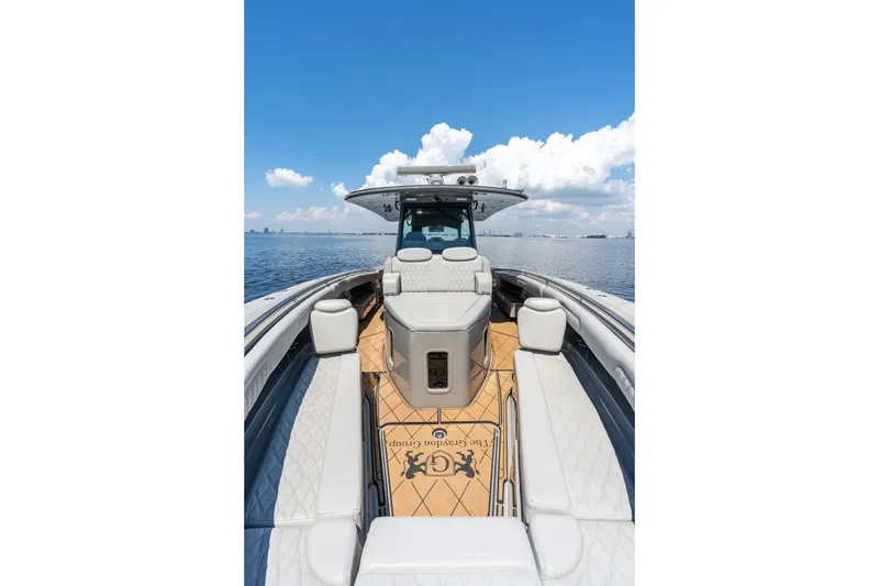 Slide: The Image of 2023 HCB 42 Lujo luxury boat on calm water under blue sky. - 18