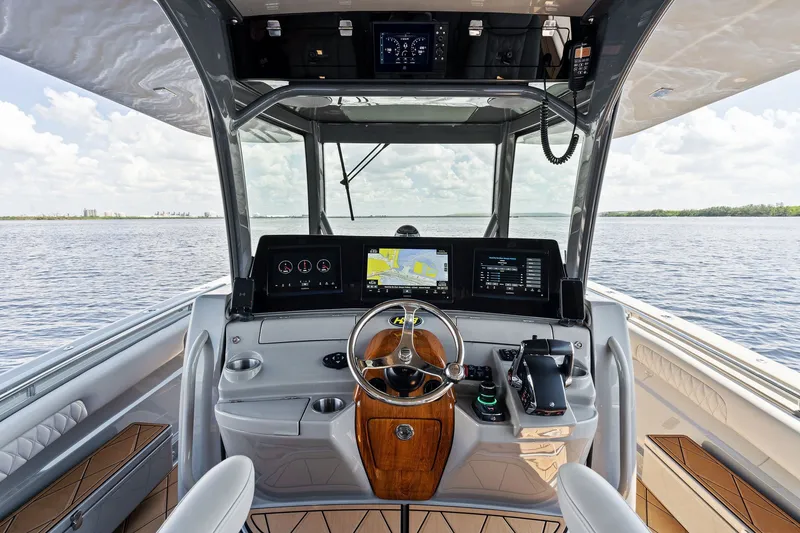Slide: The Image of Helm of 2023 HCB 42 Lujo boat with advanced navigation systems on open water. - 39