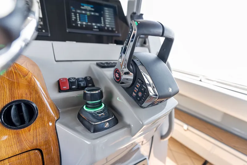 Slide: The Image of Control panel of 2023 HCB 42 Lujo boat with joystick and throttle. - 51