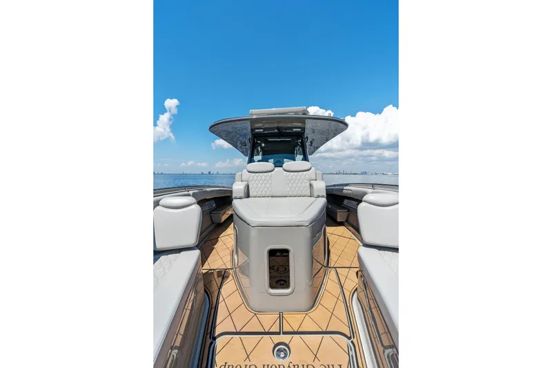 Slide: The Image of 2023 HCB 42 Lujo luxury boat interior with seating, under a clear blue sky. - 20