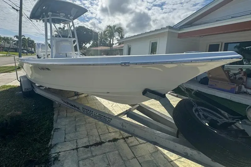Slide: The Image of 2018 Blue Wave 2400 PureBay boat on trailer, parked in residential driveway. - 3