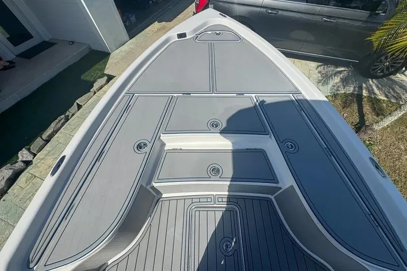 Slide: The Image of 2018 Blue Wave 2400 PureBay boat deck with sleek gray finish and storage compartments. - 23