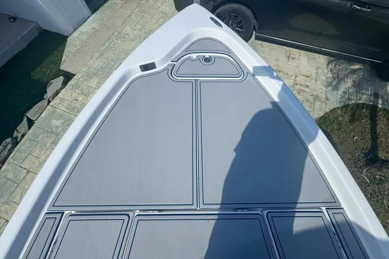 Slide: The Image of 2018 Blue Wave 2400 PureBay boat deck with sleek gray design and shadow. - 28
