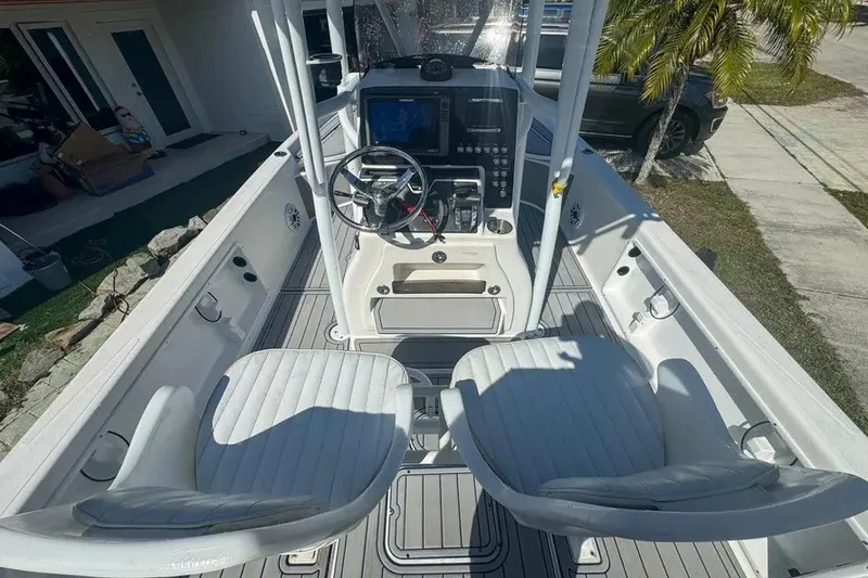 Slide: The Image of 2018 Blue Wave 2400 PureBay boat interior with dual seats and control panel. - 18