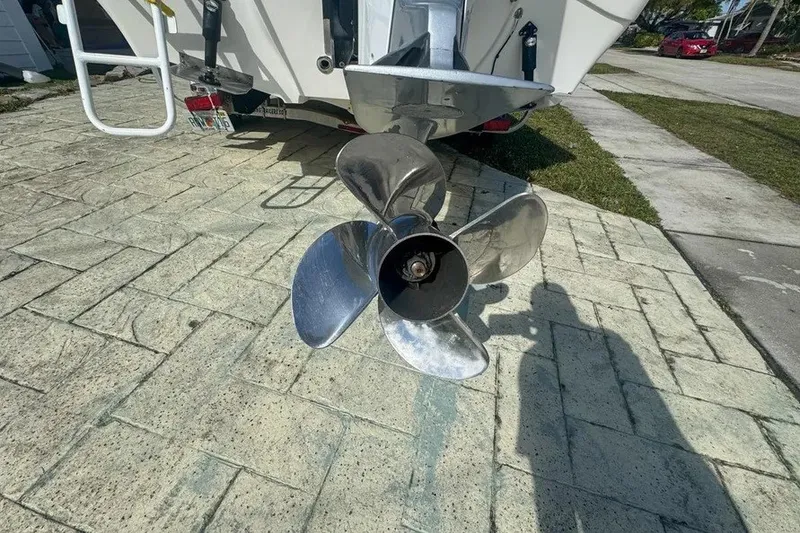 Slide: The Image of Propeller of a 2018 Blue Wave 2400 PureBay boat on a paved driveway. - 69