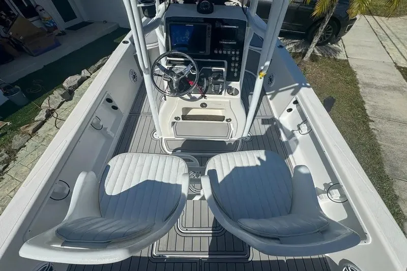 Slide: The Image of 2018 Blue Wave 2400 PureBay boat interior with dual seats and control panel. - 17
