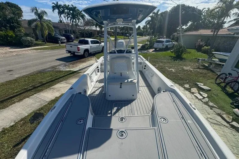 Slide: The Image of 2018 Blue Wave 2400 PureBay boat parked in residential area, sunny day. - 33