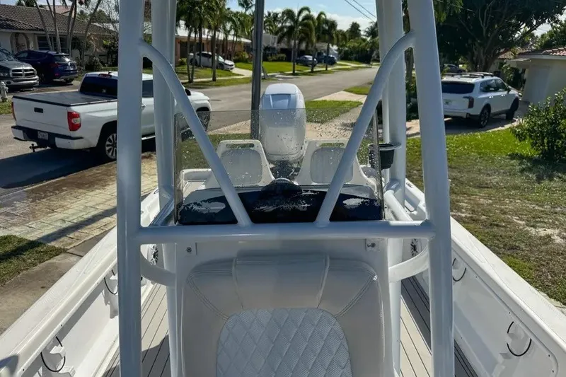 Slide: The Image of 2018 Blue Wave 2400 PureBay boat parked in a residential area, showcasing its sleek design. - 41