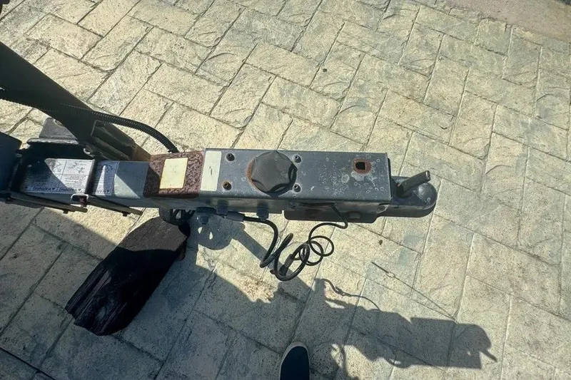 Slide: The Image of Trailer hitch of a 2018 Blue Wave 2400 PureBay boat on a paved surface. - 76