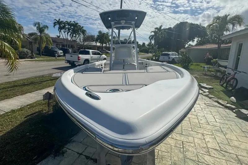 Slide: The Image of 2018 Blue Wave 2400 PureBay boat parked in a residential driveway. - 7