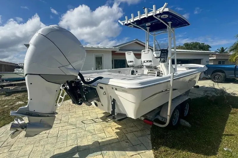 Slide: The Image of 2018 Blue Wave 2400 PureBay boat on trailer, featuring a powerful outboard motor. - 6