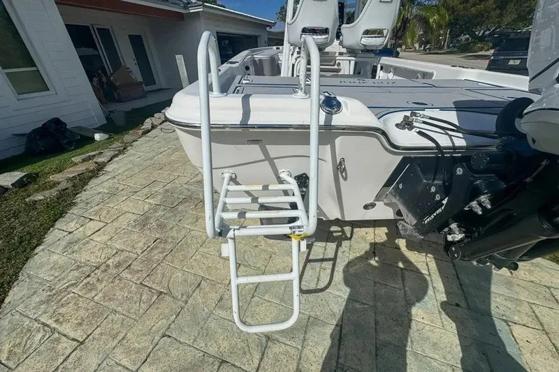 Slide: The Image of 2018 Blue Wave 2400 PureBay boat with ladder on paved driveway. - 9