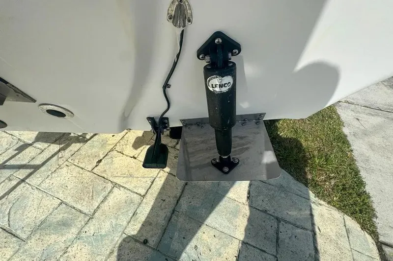 Slide: The Image of 2018 Blue Wave 2400 PureBay boat with Lenco trim tab on paved surface. - 73