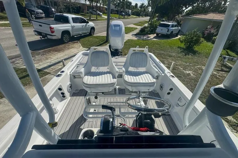 Slide: The Image of 2018 Blue Wave 2400 PureBay boat interior with dual seats and steering console. - 48
