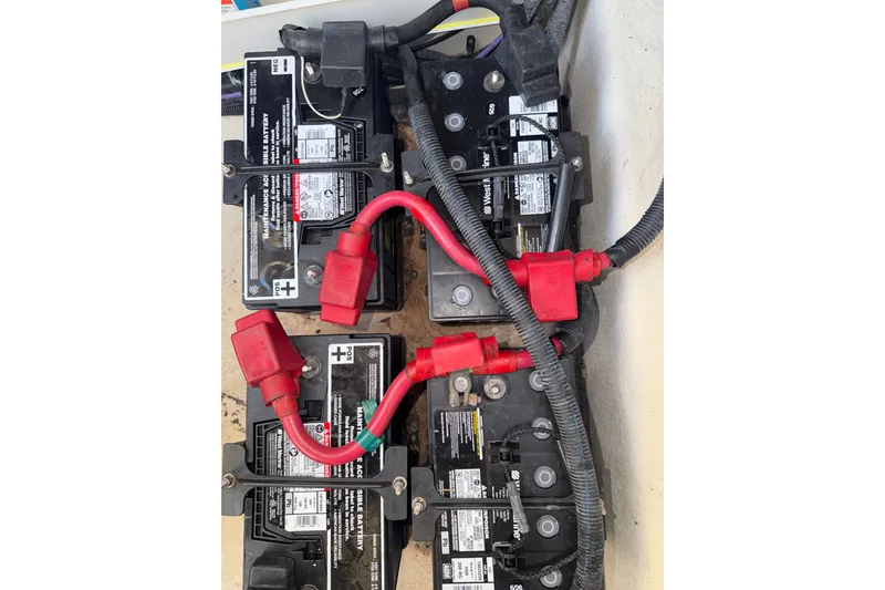 Slide: The Image of Battery setup in a 2012 Sea Ray 335 Sundancer boat with red cables connected. - 18