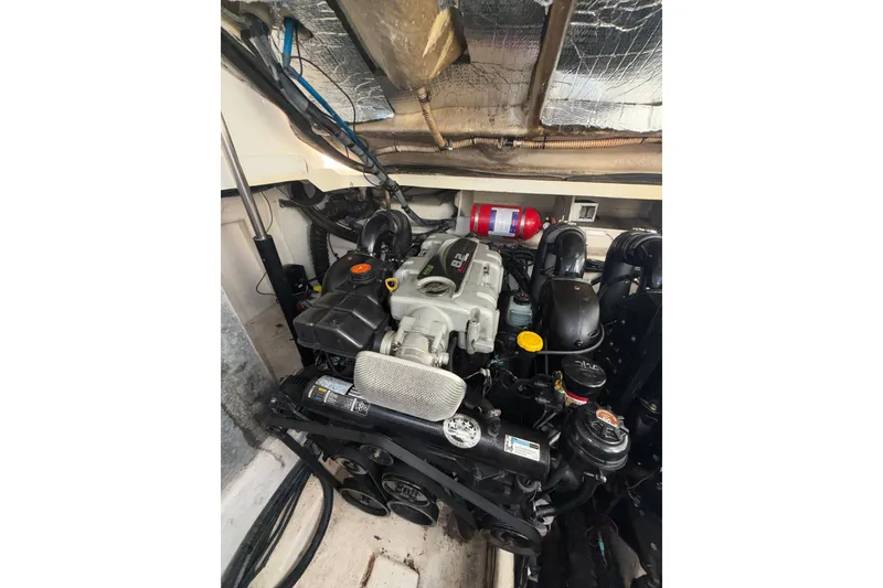 Slide: The Image of Engine compartment of a 2012 Sea Ray 335 Sundancer boat, showcasing mechanical components. - 15