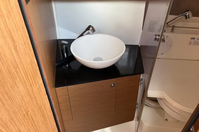 Slide: The Image of 2019 Jeanneau Leader 9.0 WA boat bathroom with modern sink and toilet. - 15