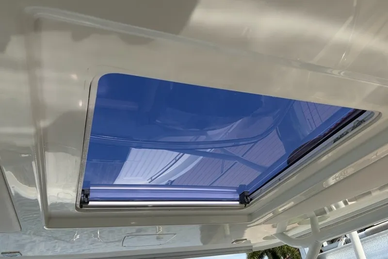 Slide: The Image of Sunroof of 2019 Jeanneau Leader 9.0 WA boat, showcasing sleek design and blue-tinted glass. - 10