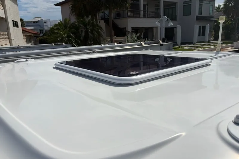 Slide: The Image of 2019 Jeanneau Leader 9.0 WA boat roof with a closed hatch, residential background. - 22