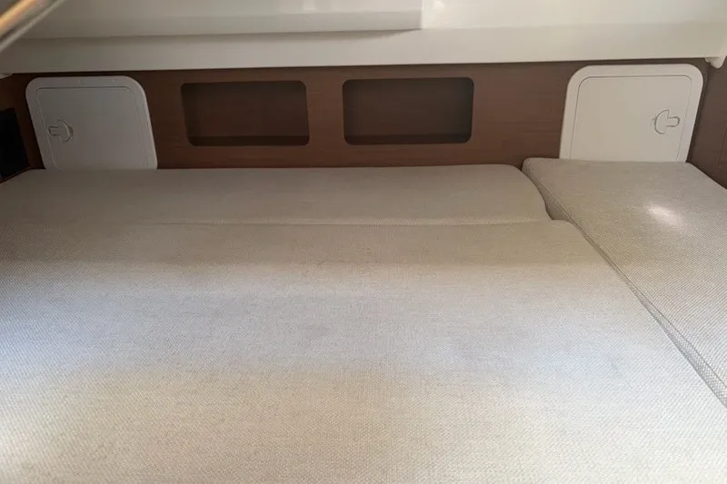 Slide: The Image of Interior cabin of 2019 Jeanneau Leader 9.0 WA with beige bedding and storage compartments. - 17