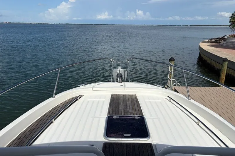Slide: The Image of 2019 Jeanneau Leader 9.0 WA boat docked by a serene waterfront. - 18