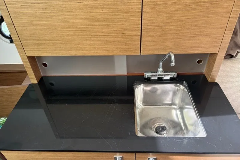 Slide: The Image of Modern kitchenette with stainless steel sink in 2019 Jeanneau Leader 9.0 WA boat. - 12
